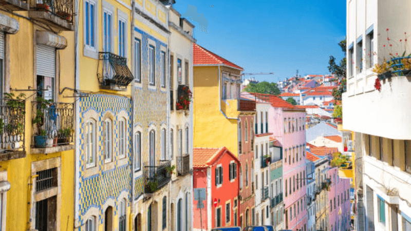 Panoramic view of Lisbon’s cityscape with colorful buildings and rooftops.